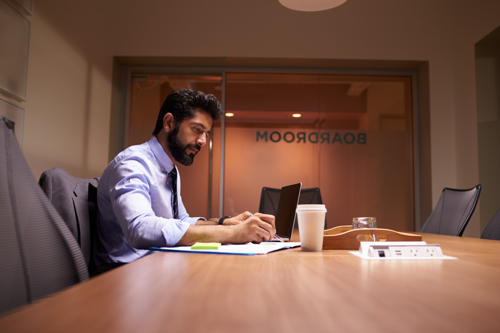 man with beard working in boardroom
