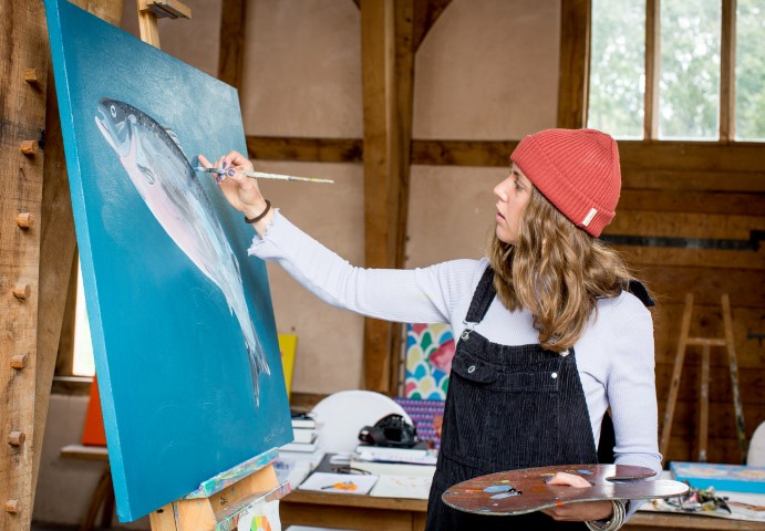 artist Alice Straker painting canvas of a fish