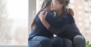 Mom and daughter hugging Mom and daughter hugging