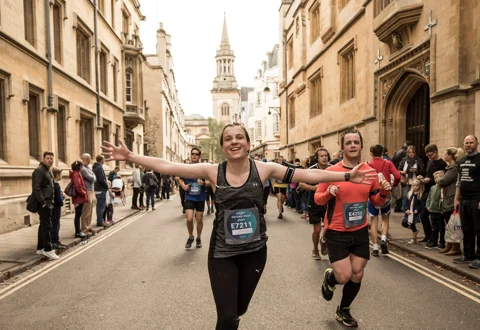 Oxford marathon runner with arms open Oxford marathon runner with arms open