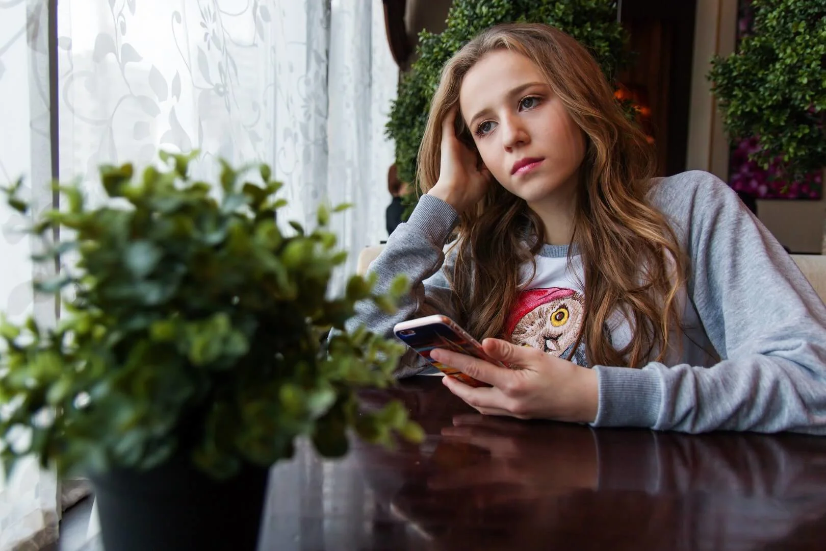 Teen girl holding phone