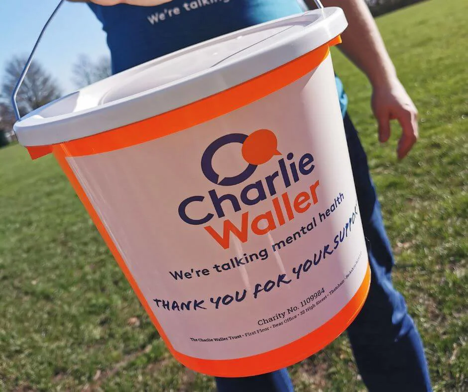 Charlie Waller Trust donation bucket being held by man Charlie Waller Trust donation bucket being held by man