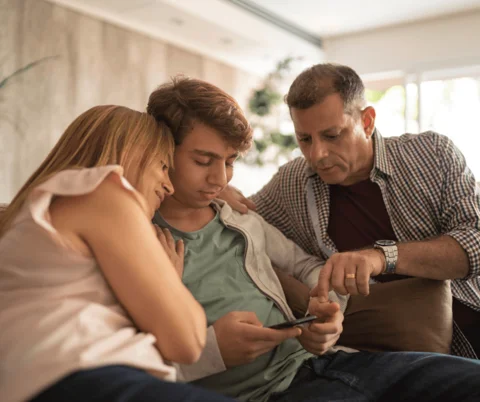 Family Looking Over Boys Shoulder Family Looking Over Boys Shoulder
