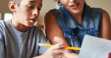 Parent helping child with homework Parent helping child with homework