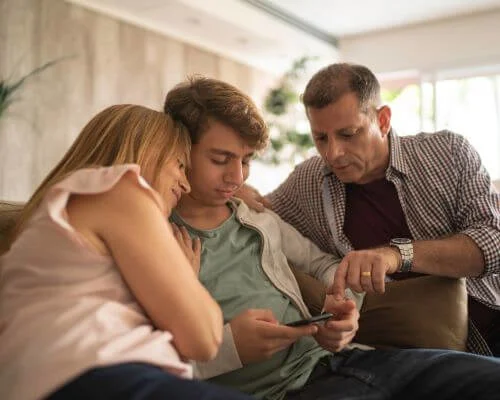 Parents and son looking at a phone Parents and son looking at a phone