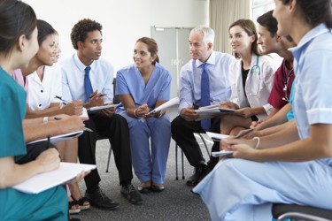 Healthcare workers sat having conversation 