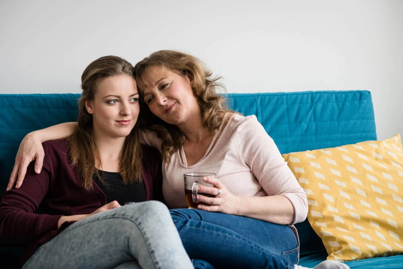 Mother with arm around daughter