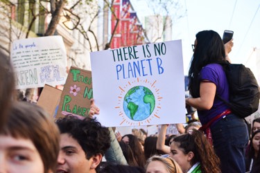 Image of a protest with a sign that says 'there is no planet b'