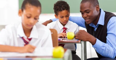 Teacher helping a pupil Teacher helping a pupil